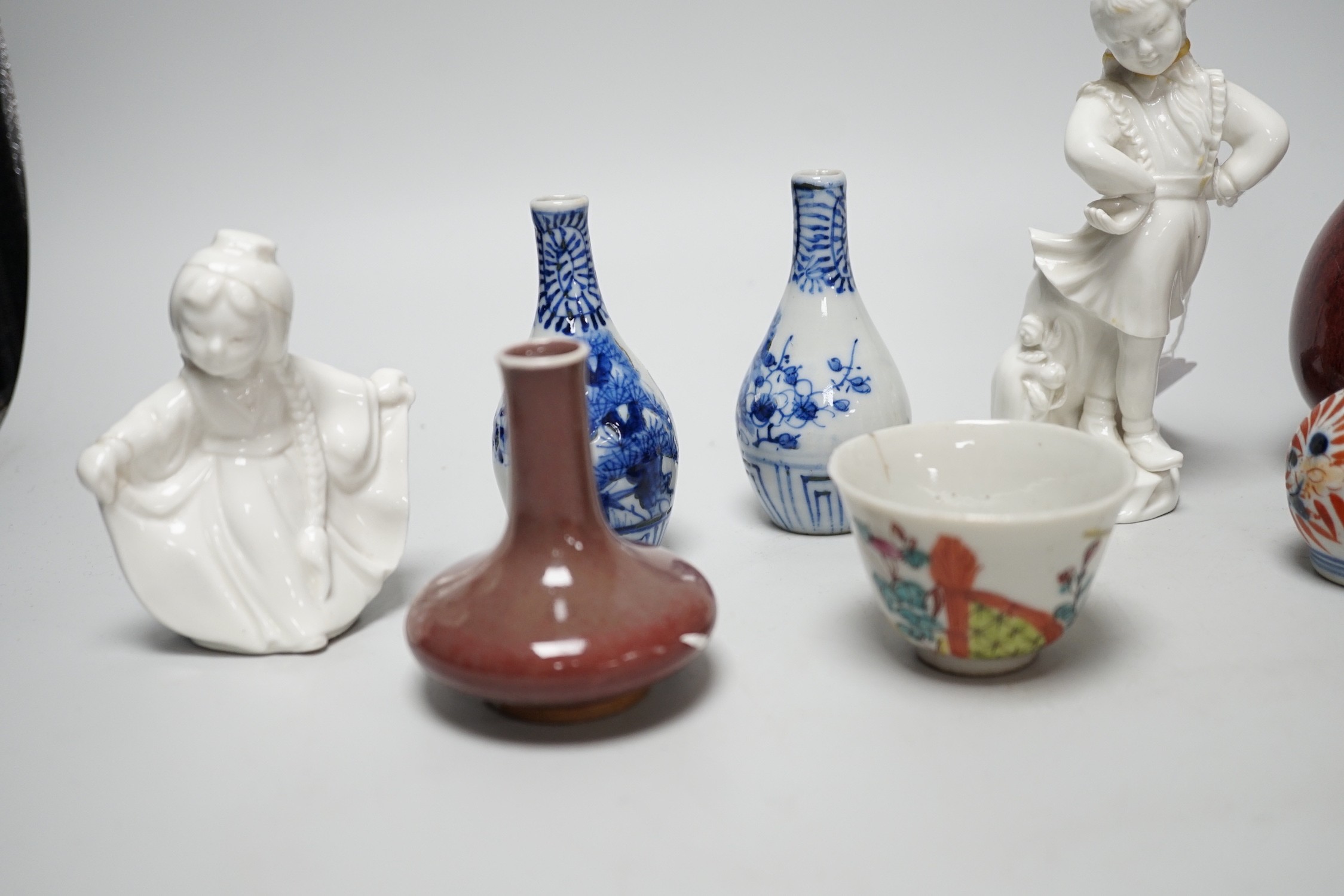 A Chinese sang de boeuf bottle neck vase, together with four Chinese miniature vases, three Chinese figures and a Chinese tea bowl, tallest 15cm